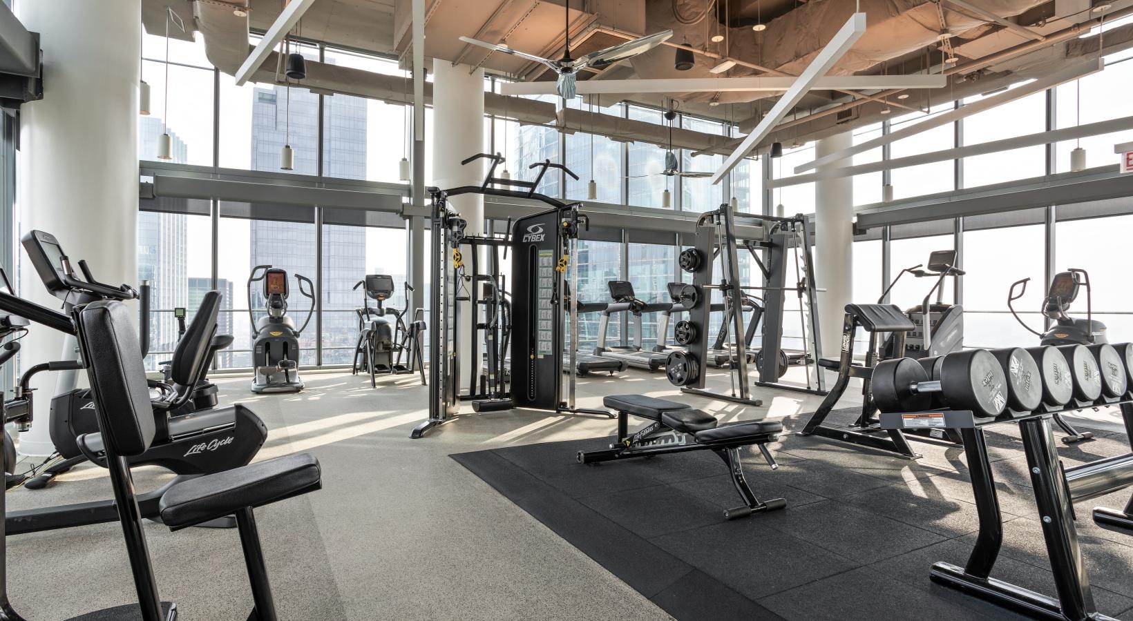 Get your workout on spacious gym with exercise equipment and high ceilings