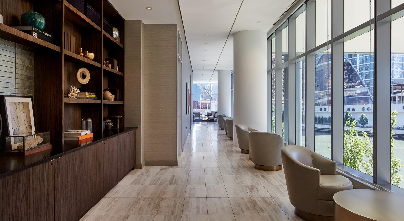 Enjoy our resident-only features hall with bookshelves and chairs looking out at the river and city